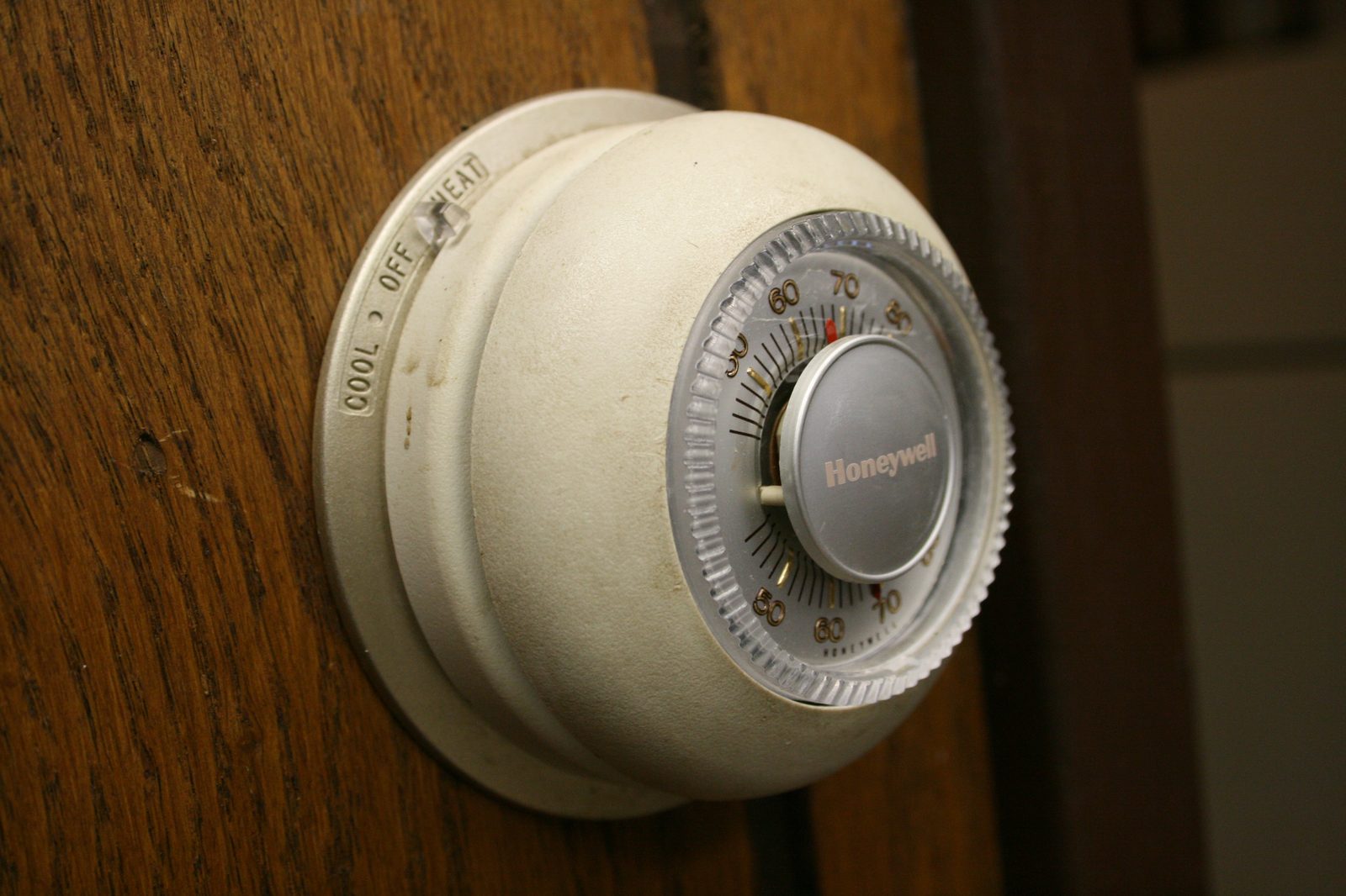 Round dial thermostat on a wall
